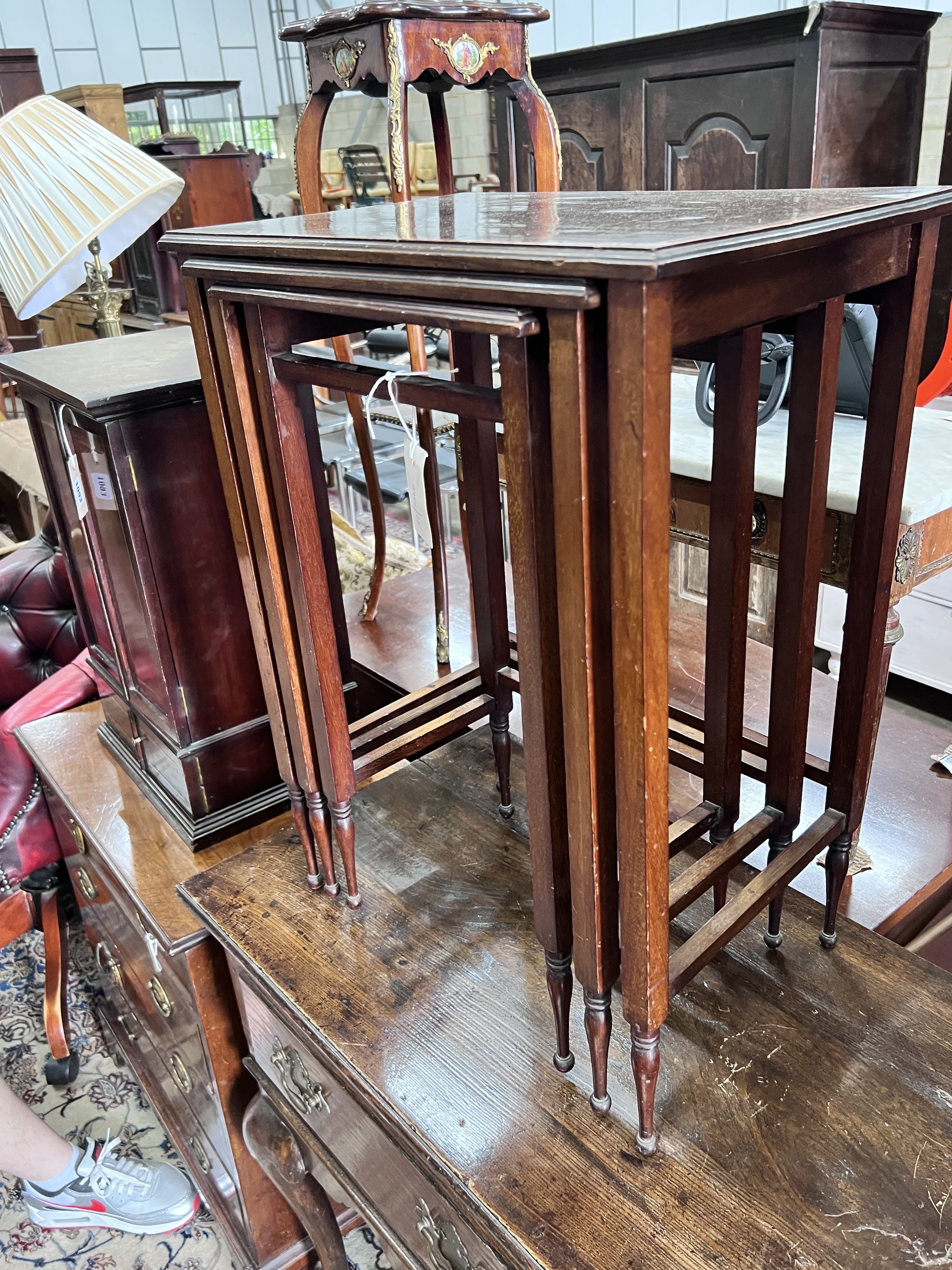 A nest of three Edwardian satinwood banded rectangular mahogany tea tables, width 48cm, depth 32cm, height 64cm